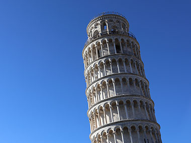 Leaning Tower of Pisa top floors with blue sky behind it