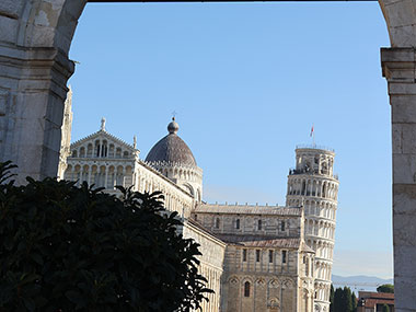 Leaning Tower of Pisa in distance beyond archway