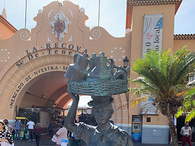 Statue of lady in front of market