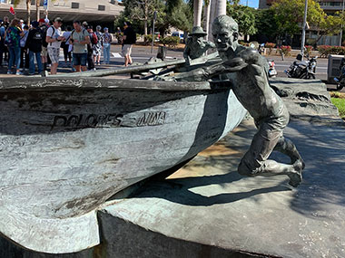 Statue of men pushing boat