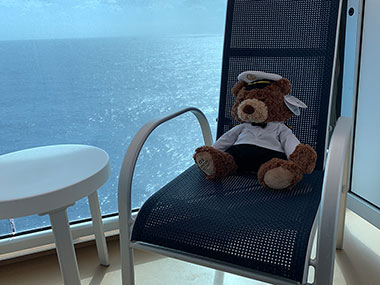 Captain teddy bear sitting on balcony