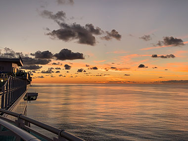 Puffy clouds over water following November 28, 2023 Sunset