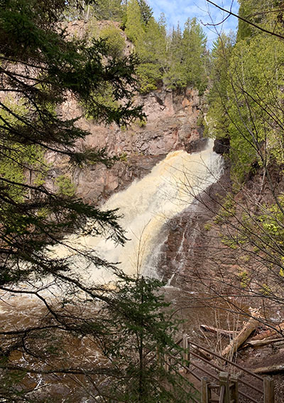 Caribou Falls behind tree branches