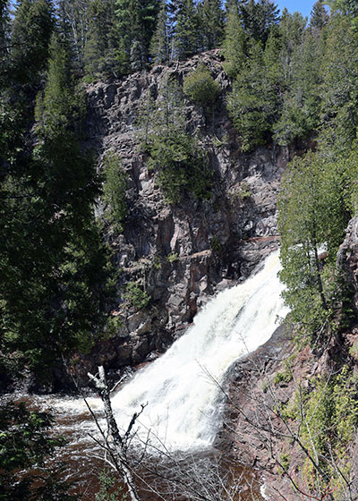 Waterfall surrounded by rocky cliff