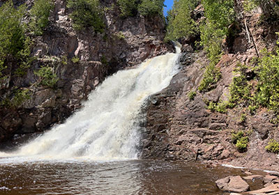 Waterfall beyond still water