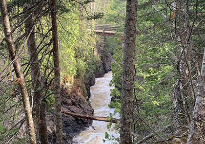 Cascade River flowing under foot bridge