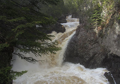 Waterfall swirls down river