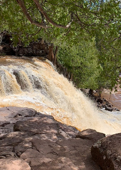 waterfall flows over rock