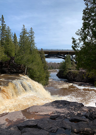 Waterfall with a bridge in the distance