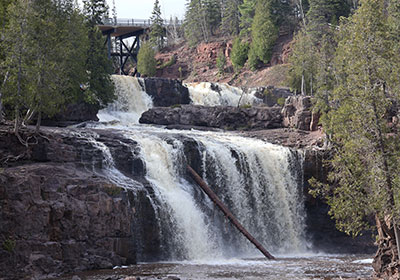 Waterfall with bridge in background