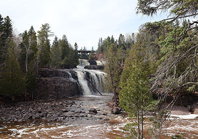 Foam on river in front of waterfall