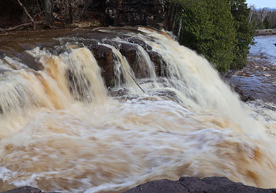 Upper waterfall with water rushing over it