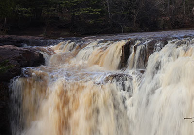 Water flows over upper waterfall