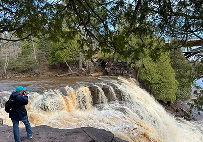 Pat taking picture in front of waterfall