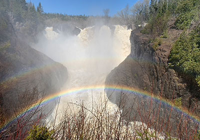 Rainbow in front of waterfall