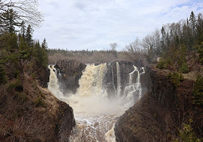 Trees line both sides of waterfall