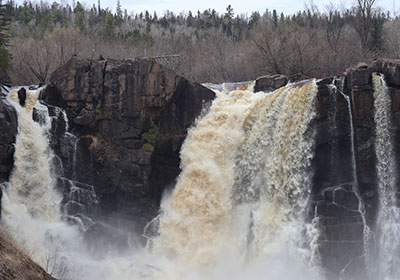 Rock sticks out of waterfall