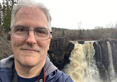 Closeup of Pat in front of waterfall