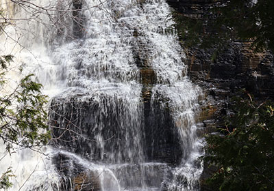 Closeup of water flowing over waterfall