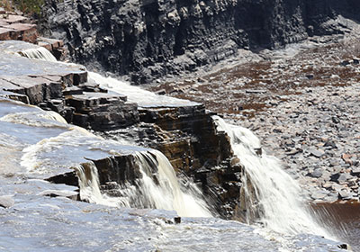 Closeup of water flowing over waterfall