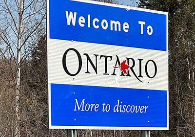 Street sign: Welcome to Ontario - More to Discover