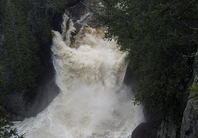 Water rushes over waterfall