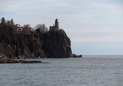 Lighthouse in shadow of clouds