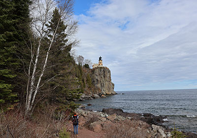 Person taking picture of lighthouse