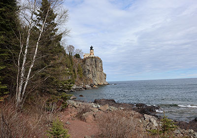 Lighthouse overlooking beach and lake