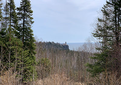 Lighthouse and Lake Superior beyond trees