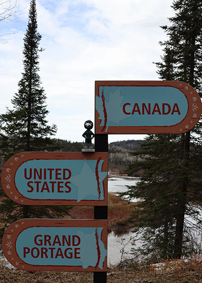 Directional signs to Canada, United States, and Grand Portage