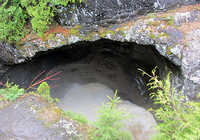 Waterfall flows into a cave