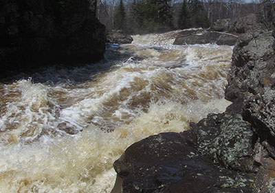 Temperance River with white puffy clouds behind