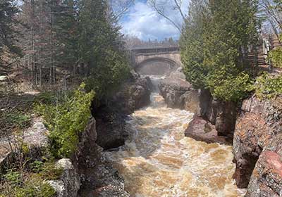 Temperance River flows under road