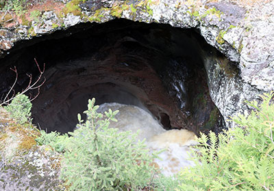 River water going into cave