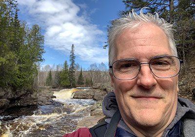 Pat in front of river