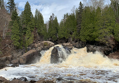 Waterfall beyond rock