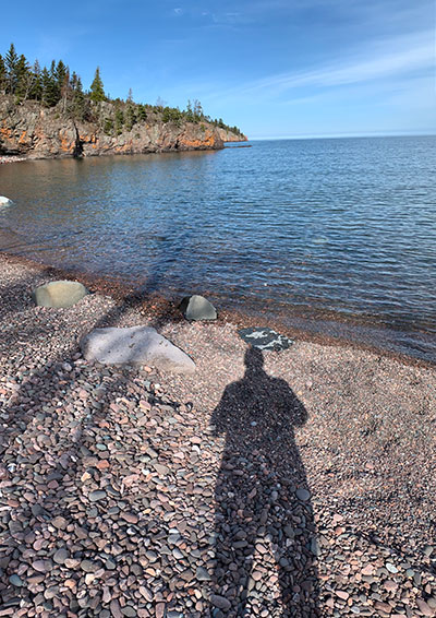 Shadow of person front of river