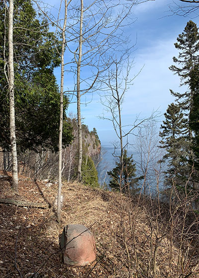 Rock with shoreline in distance