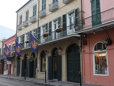 Flags hang from second floor balcony