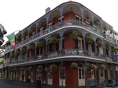 Red three story building with balconies