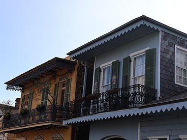Two buildings with black window shutters