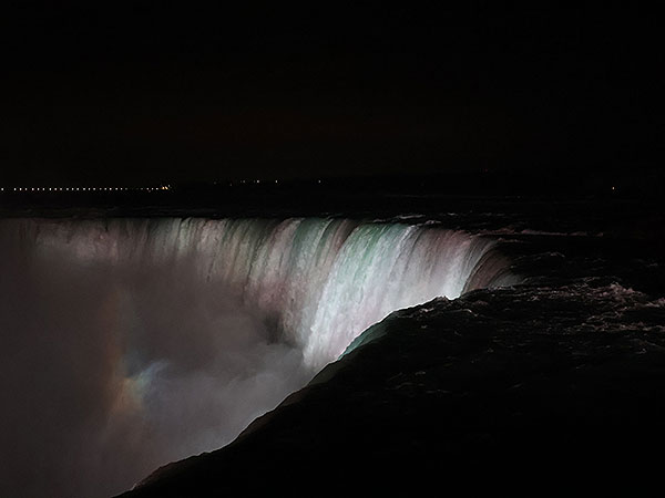 White light shines on Niagara Falls as viewed from Canadian side