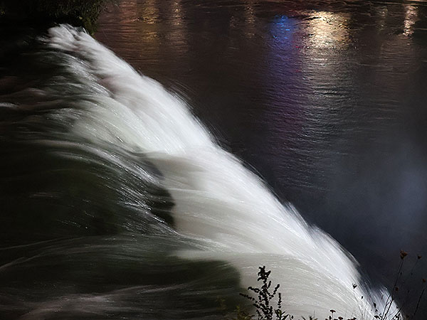 Close up of water flowing over Niagara Falls on American side at night