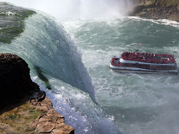 Sightseeing boat moves toward waterfall