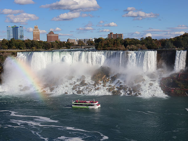 Rainbow over Niagara Falls as viewed from Canadian side with boat