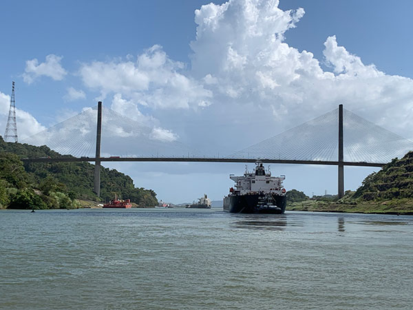 Ship passes under a bridge