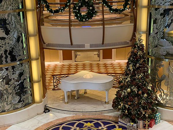 Christmas tree next to piano
